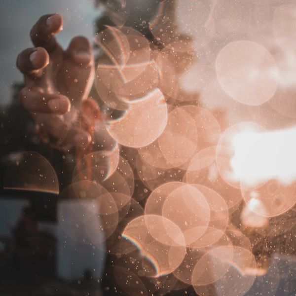 Silhouette of a person meditating against a warm, glowing background.